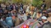 People mourn over the graves of relatives who were killed in fresh sectarian violence in Kurram on November 22. 