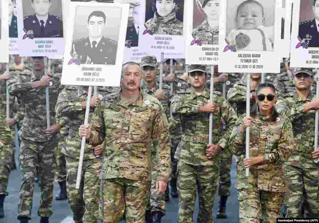 Azerbaijani President Ilham Aliyev and his wife, Vice President Mehriban Aliyeva, lead the march through Baku on September 27 to commemorate those killed during the six weeks of fighting. According to Azerbaijani officials, 2,905 Azerbaijani servicemen and 100 civilians died in the fighting. 