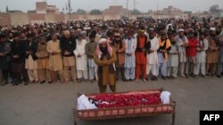 People gather to offer funeral prayers by the body of a Pakistani prisoner executed in January 2015. Pakistan lifted a six-year moratorium on the death penalty after militants killed more than 150 people at a school in the northwestern city of Peshawar in December 2014. 