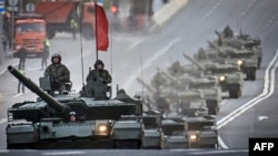 Russian T-90M tanks travel through central Moscow during a rehearsal for the May 9 Victory Day parade.